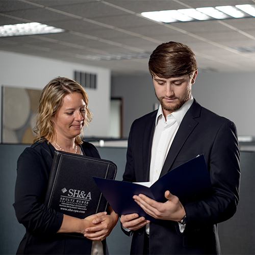 woman and man standing in office